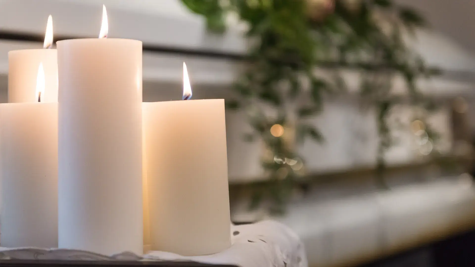 Lit candles beside a casket, symbolizing remembrance, peace, and reflection at Kane Fetterly Funeral Home in Montreal