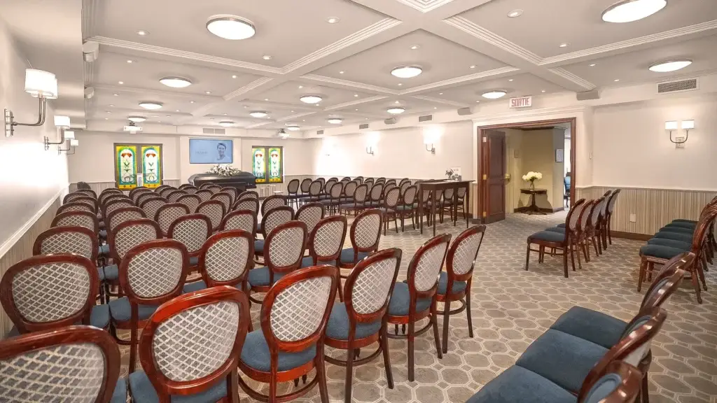 Chapel at Kane Fetterly Funeral Home in Montreal arranged for a funeral service with casket, flowers, and video tribute display