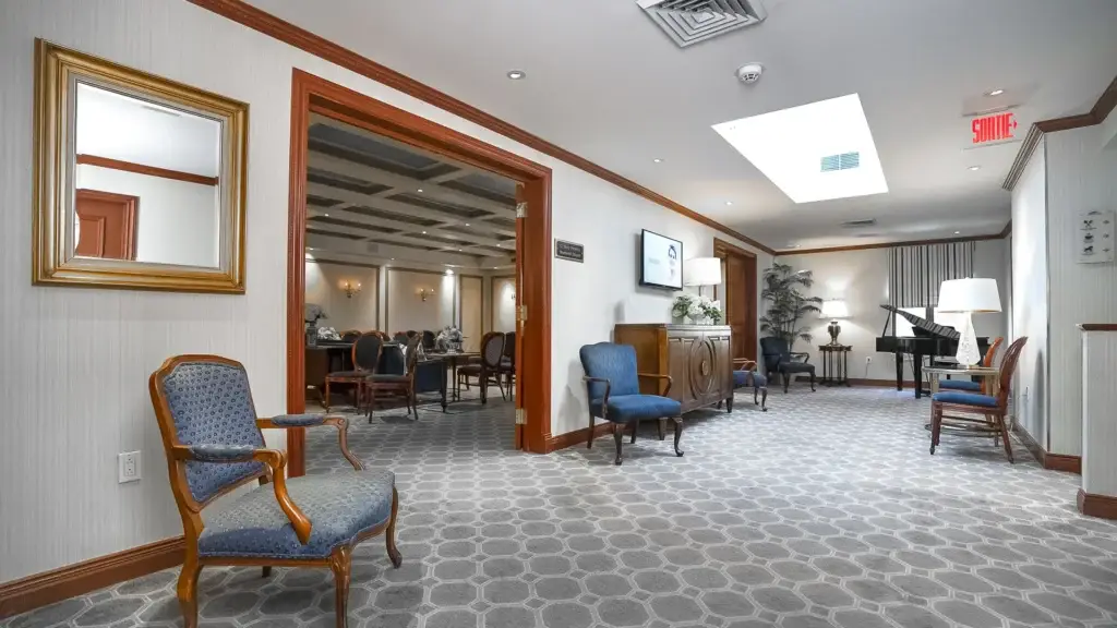 Hallway and receiving area at Kane Fetterly Funeral Home in Montreal with comfortable seating and piano