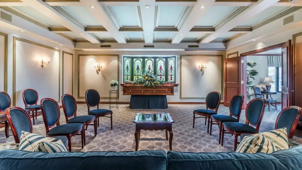 Visitation room at Kane Fetterly Funeral Home in Montreal arranged with a casket, floral tributes, and elegant seating