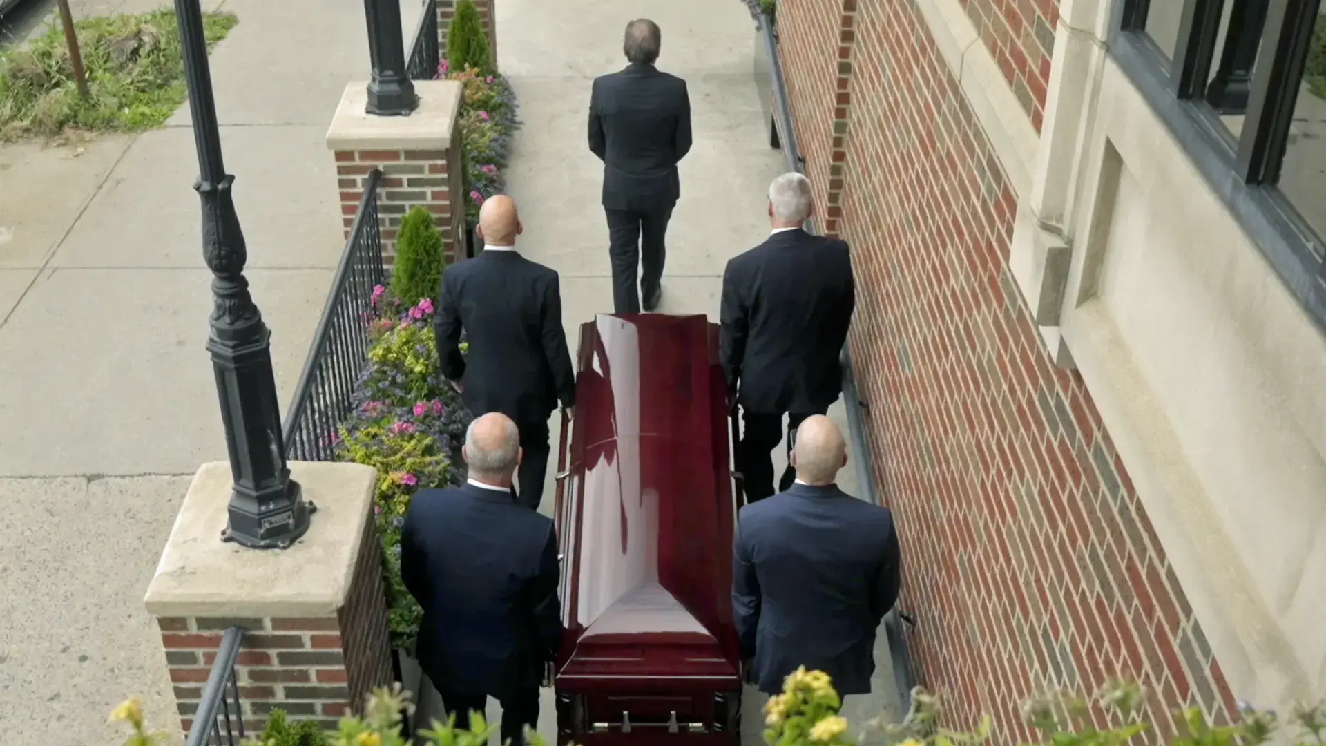 Pallbearers accompanying a casket during a burial service at Kane Fetterly Funeral Home in Montreal.