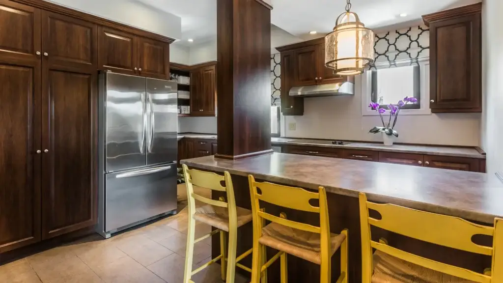 Family kitchen at Kane Fetterly Funeral Home in Montreal with warm wood cabinetry, stainless steel appliances, and a welcoming space for families.