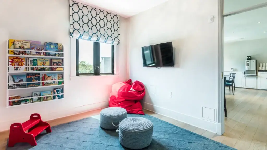 Children’s room at Kane Fetterly Funeral Home in Montreal featuring book display, television, beanbag seating, and a bright, welcoming space for families with children